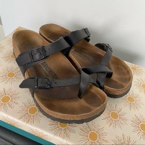Black Birkenstocks with crisscrossing straps